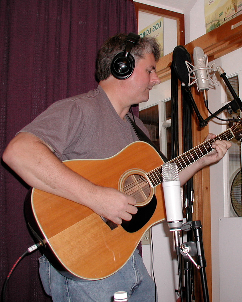 Man holding and playing a guitar